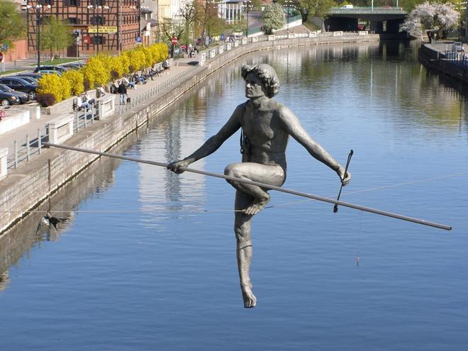 man balancing sculptures by jerzy