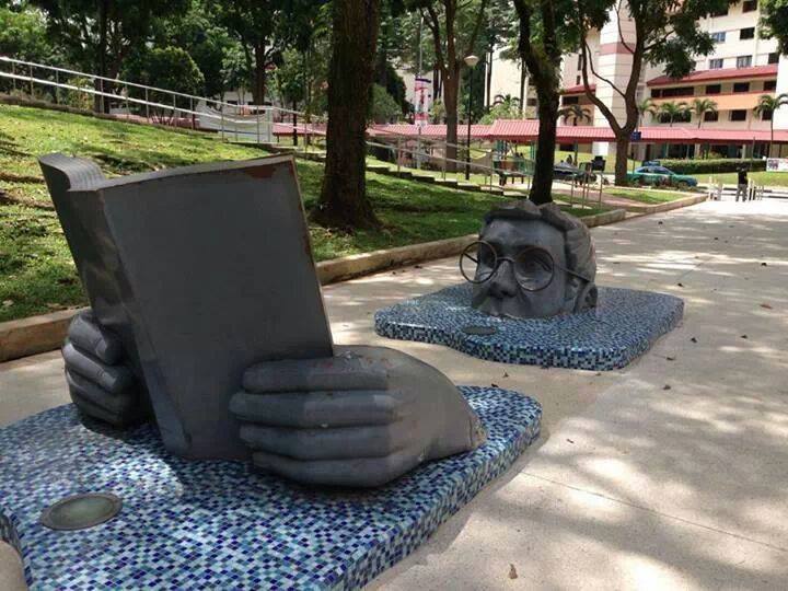 man book reading sculpture